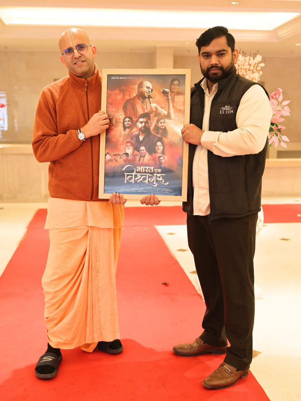 Nitin Vashisth presenting a film poster